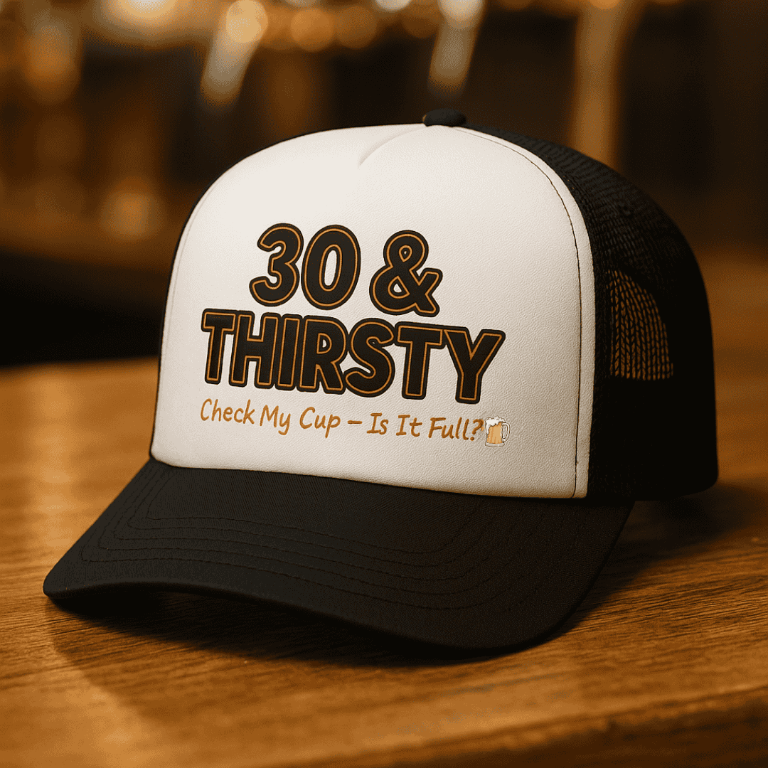 Black and white cap with '30 & Thirsty' text on a wooden surface